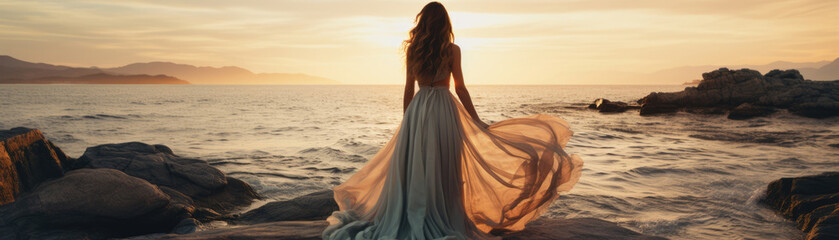 Fototapeta na wymiar Young woman in a beautiful dress on the beach