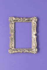 Gold frame on purple background. Minimal fashion, modern and background concept.