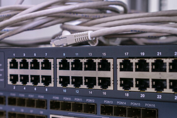 There is a close-up of an Internet communication switch with many empty ports. Interfaces for connecting cable Internet lines
