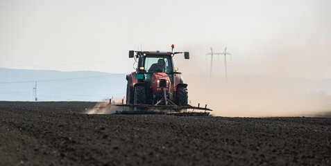 Fototapeta premium Tractor working in the field