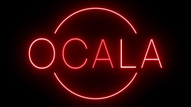 Flickering red retro style neon sign glowing against a black background for OCALA