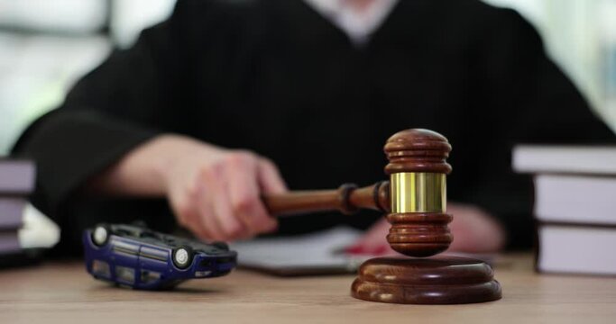 Overturned car and judge with a gavel in court. Circumstances of the accident are being investigated in court