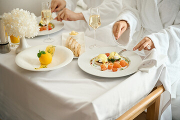 Hotel guests have breakfast in bathrobes