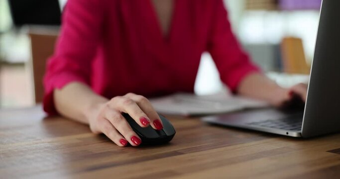Business woman manually typing on computer keyboard using a mouse sitting at desk in office or working at home. Remote work teleworking or searching for information on network
