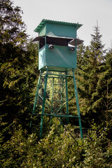 
A green hunter's observation tower in the forest