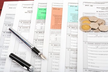 Polish tax forms documents with pen and coins