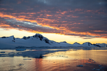Beautiful Antarctica landscape, mountains next to the sea with breathtaking reflection during...