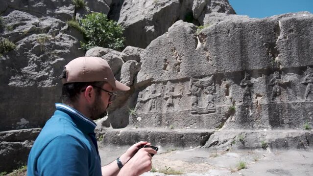 An archaeologist conducts research using modern methods in Yazilikaya in Hattusa, ancient capital of the Hittite Civilization - Corum, Turkey