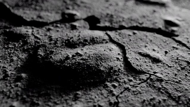 Rough rocky dark surface. Dark crumpled texture surface. Used as a background and texture.