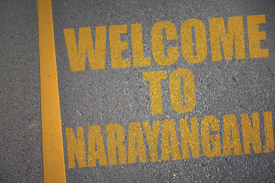 asphalt road with text welcome to Narayanganj near yellow line.