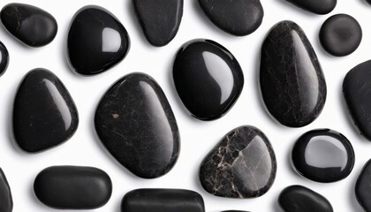 A collection of black rocks, some with reflective surfaces, are arranged in a visually appealing manner