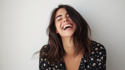 Young brunette woman over isolated white background laughing