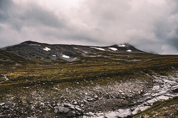 Beautiful dark mountain in Norway among the clouds.