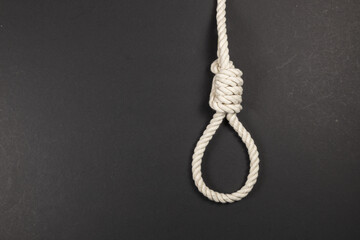 Rope noose for hangman, suicide made of natural fiber rope on dark background.