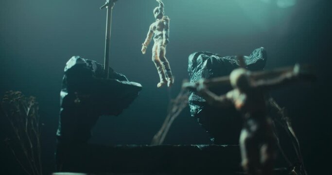 Miniature of the mummified doll hanging on the gallows