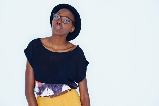 Fashion, space and portrait of black woman with attitude in studio on white background for hipster style. Model, glasses and hat with confident young african person in trendy clothing outfit