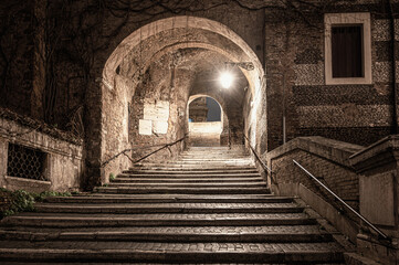 Stone stairs with arch in Rome, Italy. Small secret alley.