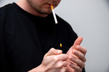 close up of a man starting to smoke a cigarette