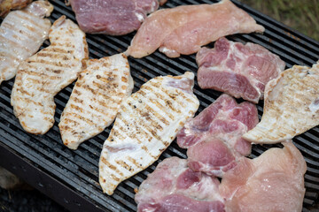 Pork (pork neck) grilled on charcoal. Shot from above. It's time to grill! Barbecue. Meat steak grilled on a stainless steel grill.	