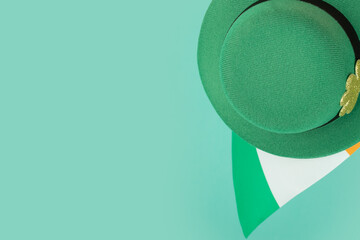 green irish leprechaun hat with gold clover and irish flag on green background