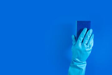 Cleaning sponge in hand, sanitation and cleanliness, professional cleanup service,blue background