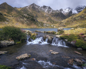 Fototapeta na wymiar Waterfall at Tristaina Lakes in the Pyrenees, Andorra
