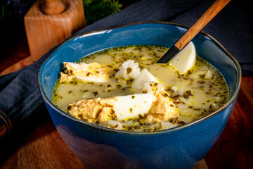 A bowl of soup sorrel with rice and boiled egg.