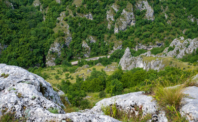 Fototapeta na wymiar Jelasnicka Klisura and the view from the Prozorac lookout point on the huge rocks and meadows that spread across the mountain (Jelasnica Klisura, Suva planina).