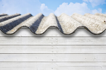 Old aged roof made of corrugated asbestos panels - dangerous materials in buildings and...