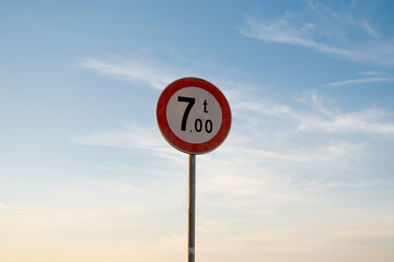 Mass limit traffic sign, isolated sunset sky.