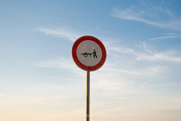 No entry for handcarts traffic sign, isolated sunset sky.