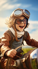 Fototapeta premium Portrait of happy little boy in aviator helmet and goggles sitting on vintage toy airplane