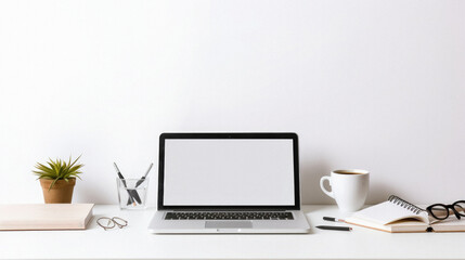 Close up of modern workspace with blank screen laptop, coffee cup, stationery and copy space on white wall background