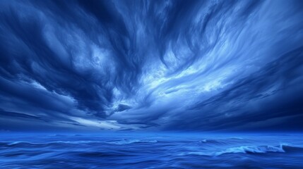 Whirling indigo storm clouds set against a twilight horizon