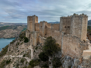 Aerial view of 15th century medieval castle ruin Castillo de Chirel in Spain above the Jucar river with partially restored walls and towers, great hiking place