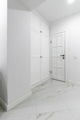 White entrance hall interior with wooden banquette with gold top