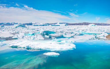 Melting of a iceberg and pouring water into the sea - Greenland - Tiniteqilaaq, Sermilik Fjord,...