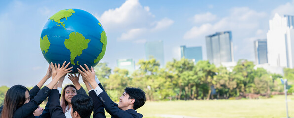 Earth day concept with big Earth globe held by group of asian business people team promoting...
