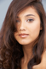 Naklejka premium Portrait, care and beauty of woman with hair in studio isolated on a grey background. Face, aesthetic and hairstyle of model in makeup cosmetics, hairdresser and salon treatment for skin glow