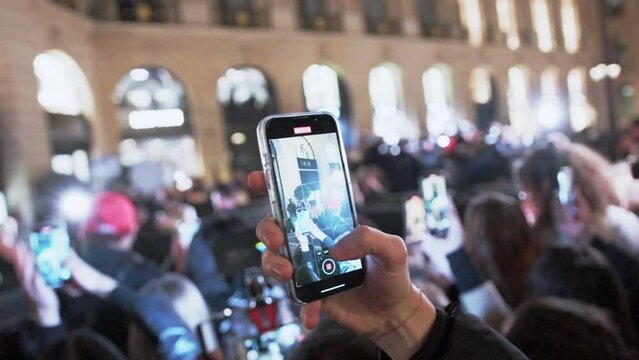Hands filming video, photo on Fashion week in Paris. Close up phones