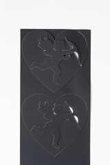 machine-cut hearts with valentine's day cupids on blank paper