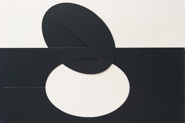black paper with oval cutout and oval form on blank paper