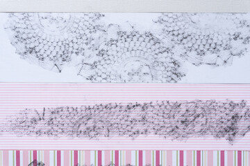paper background featuring rubbing pattern (crochet table cloth)