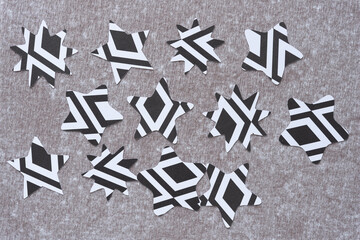 machine-cut stars with abstract black and white pattern randomly arranged on the reverse side of...