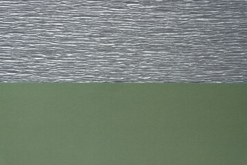 metallic silver crepe paper over solid green paper background