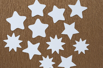 machine-cut white paper stars on golden metallic crepe paper