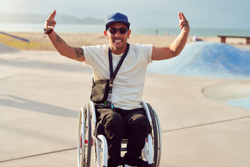 athlete man with disability in wheelchair smiling making hand gestures skatepark.