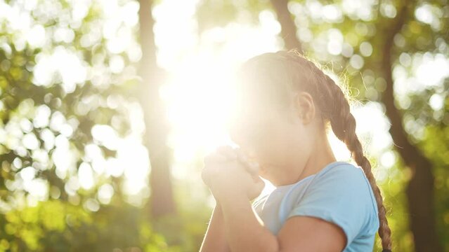 child pray. young gratitude a god religion concept. little girl in nature outdoors praying dreams of happiness lifestyle to god. praise worship freedom concept. kid praying in the forest