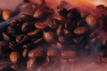  Roasted coffee beans with smoke and fire background. Close up,