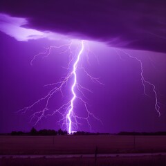 A lightning strike in a field with purple sky
